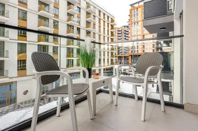 a balcony with two chairs and a table on a building at Belgrade Waterfront - Beograd na Vodi - Sensa in Belgrade