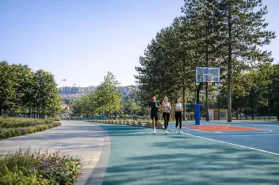 three women playing basketball on a basketball court at Metropoliten Modern Apartment in Belgrade