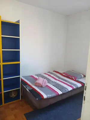 a bedroom with a bunk bed with a pink hat on it at Bezanija86 in Belgrade