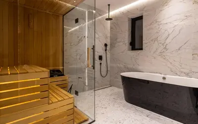 a bathroom with a shower and a bath tub at One Luxury Suites in Belgrade