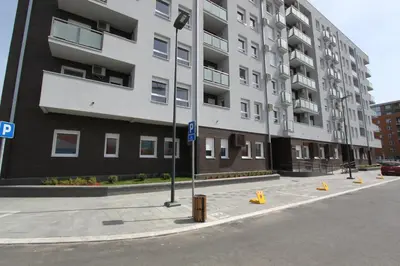 a large apartment building on a city street at Riviera 2 New Belgrade studio apartment, parking 5 evra dan in Belgrade