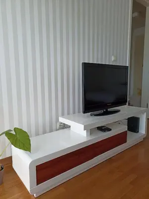 a white entertainment center with a flat screen tv on it at Apartment Tifani Belville in Belgrade