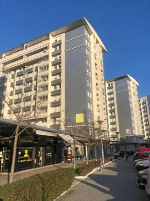 a tall building with cars parked in front of it at Belville Luxury Apartment in Belgrade