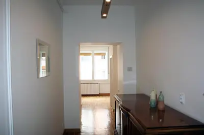 a living room with a table and a window at Apartment Auer_Belgrade in Belgrade