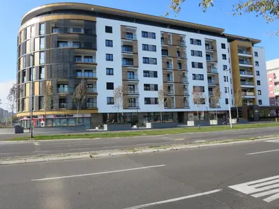 an apartment building on the corner of a street at Garden Apartment Sun City in Belgrade