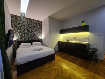 a bedroom with a bed and a dresser in it at Urban Studio in city center in Belgrade
