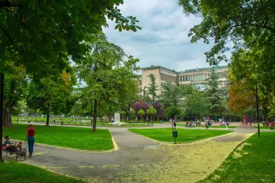 a park with people walking around and buildings at Apartment Petra 071 in Belgrade