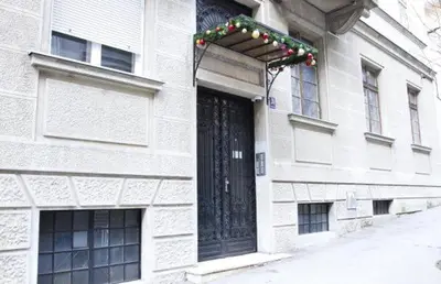 a building with a door with christmas lights on it at Crown apartment with garden view in Belgrade