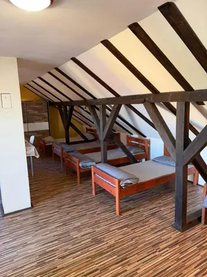 a row of benches in a room with a ceiling at Prenociste Pecinci in Pećinci