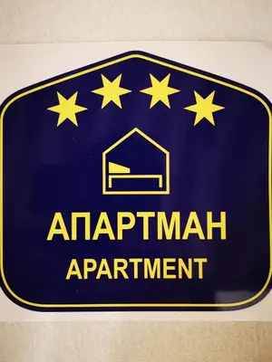 a blue sign for an apartment apartment with stars on it at Vracar Vuk 1 in Belgrade