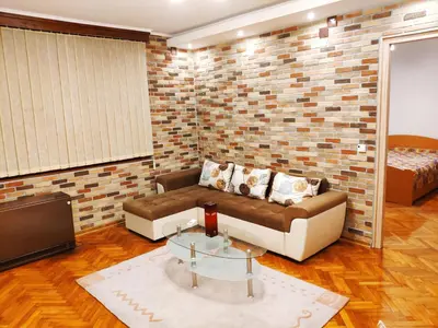 a living room with a couch and a tv at V2 with Love - Vintage Modern and Spacious in Belgrade