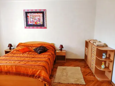 a bedroom with a bed with a cat laying on it at V2 with Love - Vintage Modern and Spacious in Belgrade