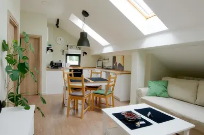 a living room with a couch a table and a kitchen at VUKAJLO apartment Belgrade in Belgrade