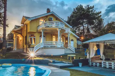 a house with a pool in front of it at Prenociste Dunav 97 K5 in Novi Banovci