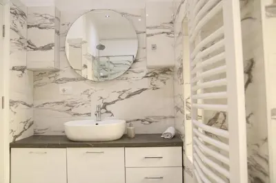a bathroom with a sink and a mirror at Natalie's Royal M in Belgrade