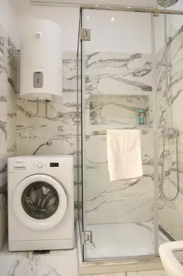a bathroom with a washing machine and a shower at Natalie's Royal M in Belgrade
