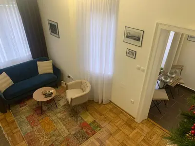 a living room with a blue couch and a chair at Old Town City Center in Belgrade