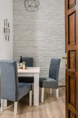 a dining room table with two chairs and a white table at 4Seasons in Sajmište