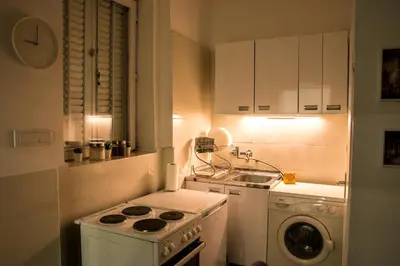 a small kitchen with a stove and a sink at 4Seasons in Sajmište