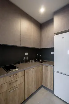 a kitchen with wooden cabinets and a white refrigerator at Belly3 in Belgrade