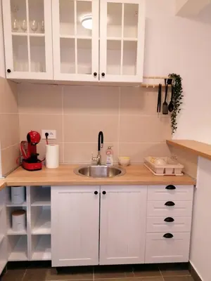 a kitchen with white cabinets and a sink at Yellow Gate in Novi Grad