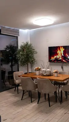 a dining room with a table and a fireplace at ADA MOMENT Splav- kuca na reci Beograd- Floating House on SAVA RIVER ,Belgrade in Belgrade