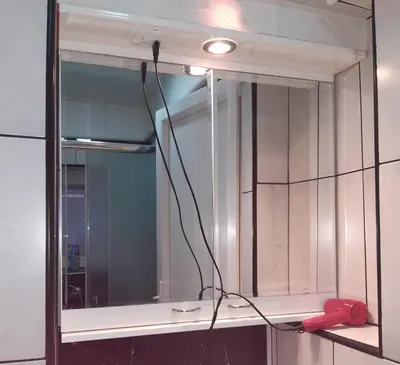 a mirror with a red phone on a shelf at Viktoria in Belgrade