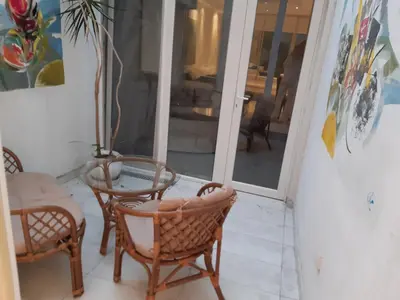 a room with two chairs and a table and a glass door at Viktoria in Belgrade