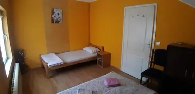 a small room with a bed and a door at Rosso Apartments in Belgrade