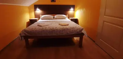 a bedroom with a bed with two towels on it at Rosso Apartments in Belgrade