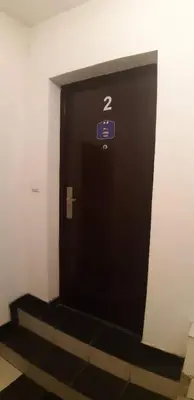 a black elevator door with a sign on it at Rosso Apartments 2 in Belgrade