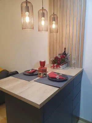 a table with two plates and napkins and lights at Downtown in Belgrade