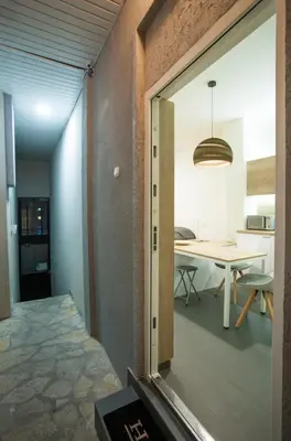 an open door to a dining room with a table at Studio 10 in Belgrade