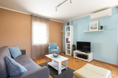 a living room with a couch and a tv at Charlie&Blueberries in Belgrade