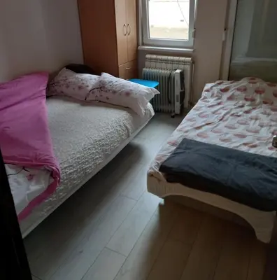 a bedroom with two beds and a window at Luna Apartment in Surčin