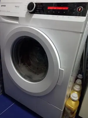 a washing machine with its door open in a room at Luna Apartment in Surčin
