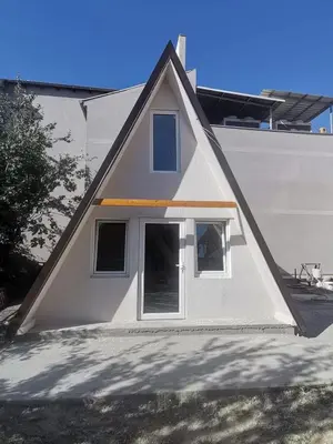 a house with a pitched roof on top of a building at ViP ROOMS PRENOCISTE 026 in Smederevo