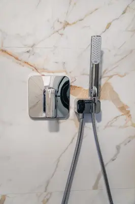 a shower head on a white marble counter at 9 Nine - Luxury Apartments & Suites in Belgrade