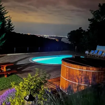 a swimming pool in a backyard at night at Vila Banda in Sremski Karlovci