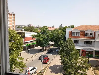 a view of a street with cars parked on the road at Stan u samom centru Obrenovca, na Trgu 2 in Obrenovac