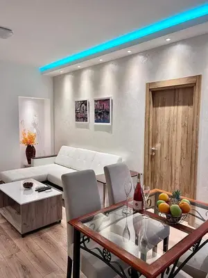 a living room with a couch and a table at Hugolina LUX in Belgrade