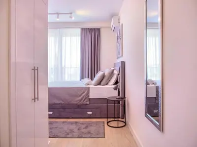 a bedroom with a bed and a mirror at BW Aurora 108 in Belgrade