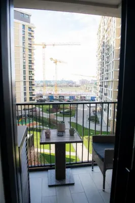a balcony with a table and a view of a building at Belgrade Waterfront Metropolitan in Belgrade