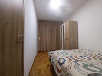a bedroom with a bed and a wooden cabinet at Apartman Ledine in Ledine