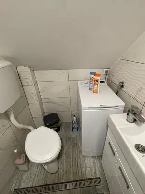 a small bathroom with a toilet and a sink at Journey Home in Belgrade