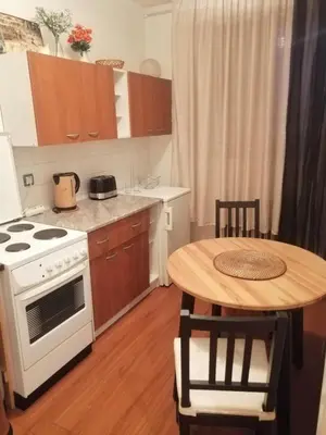 a kitchen with a white stove and a table at Apartman Centar in Belgrade