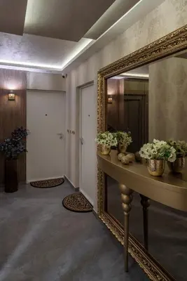 a hallway with a mirror and a table with flowers at Star32 in Vračar (historical)