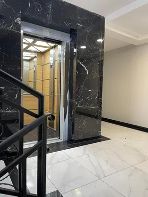 a lobby with a glass door with a marble wall at Cvetanov trg LUX 1 in Belgrade