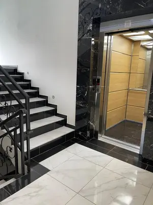 a staircase in a building with a glass door at Cvetanov trg LUX 2 in Belgrade