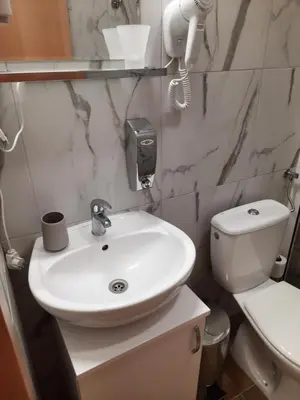 a bathroom with a white sink and a toilet at Aleksa 1 in Belgrade